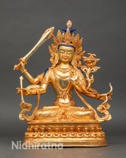 Front view of maha manjushri statue handcrafted copper gold gilded semi precious stones