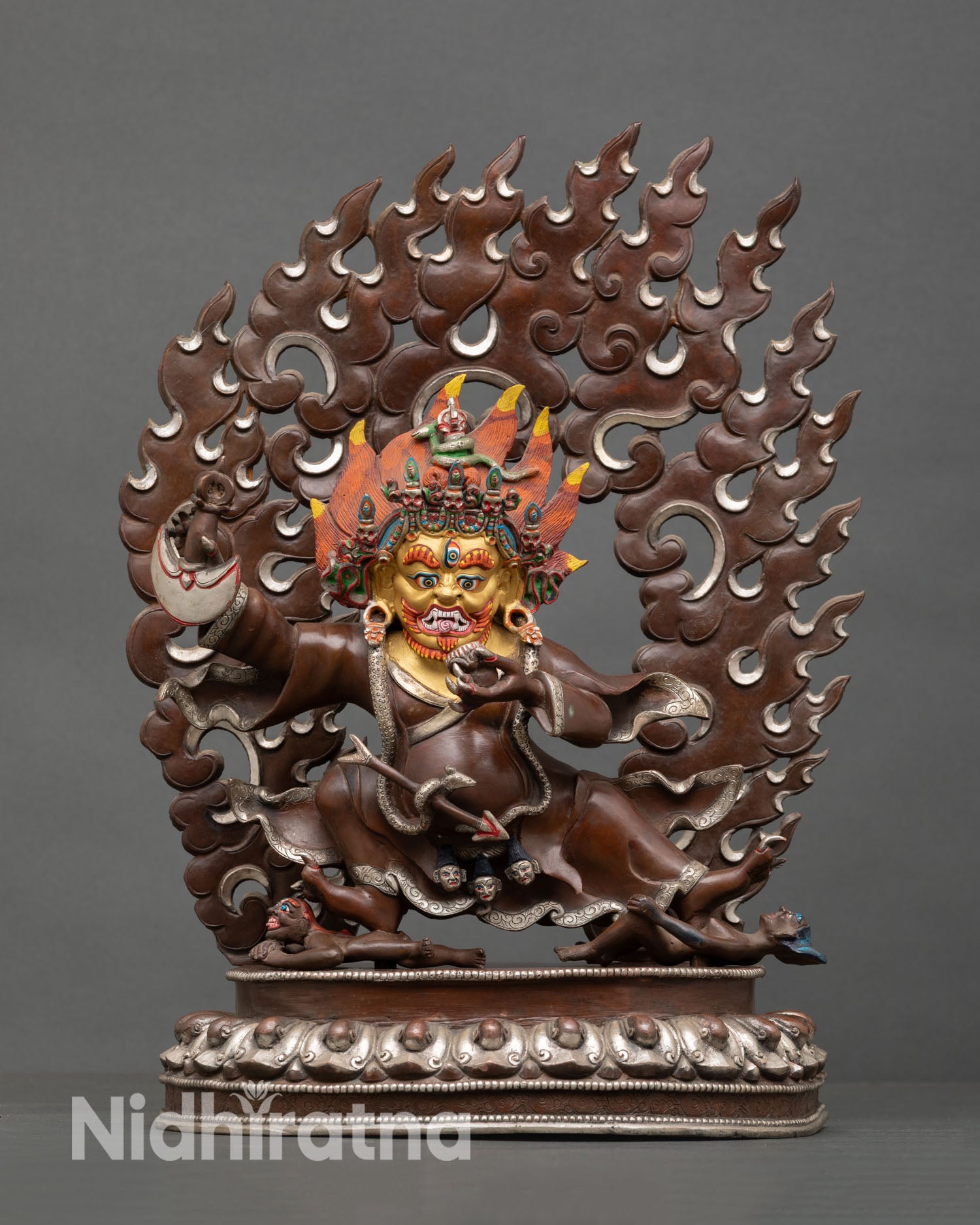 Front view of Mahakala Bernagchen statue handcrafted copper sculpture oxidized silver plated finish gold painted face wrathful protector deity