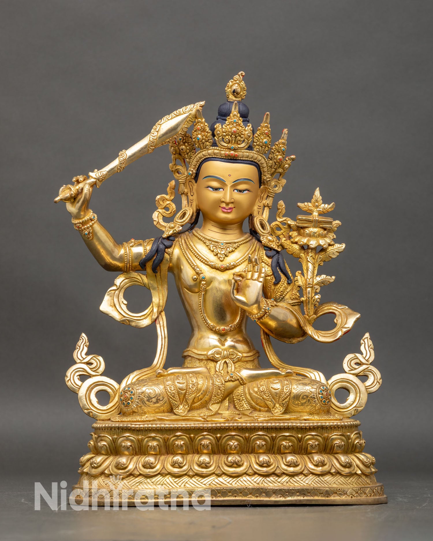 Front view of Manjushri statue Bodhisattva of wisdom handcrafted Nepalese copper gold fire gilded semi precious stones