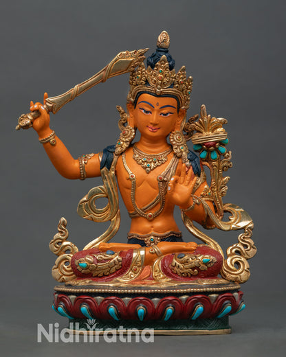 Front view of Manjushri statue copper Himalayan Buddhist sculpture lost wax casting gold gilded detailing lotus pedestal altar decor Nepal