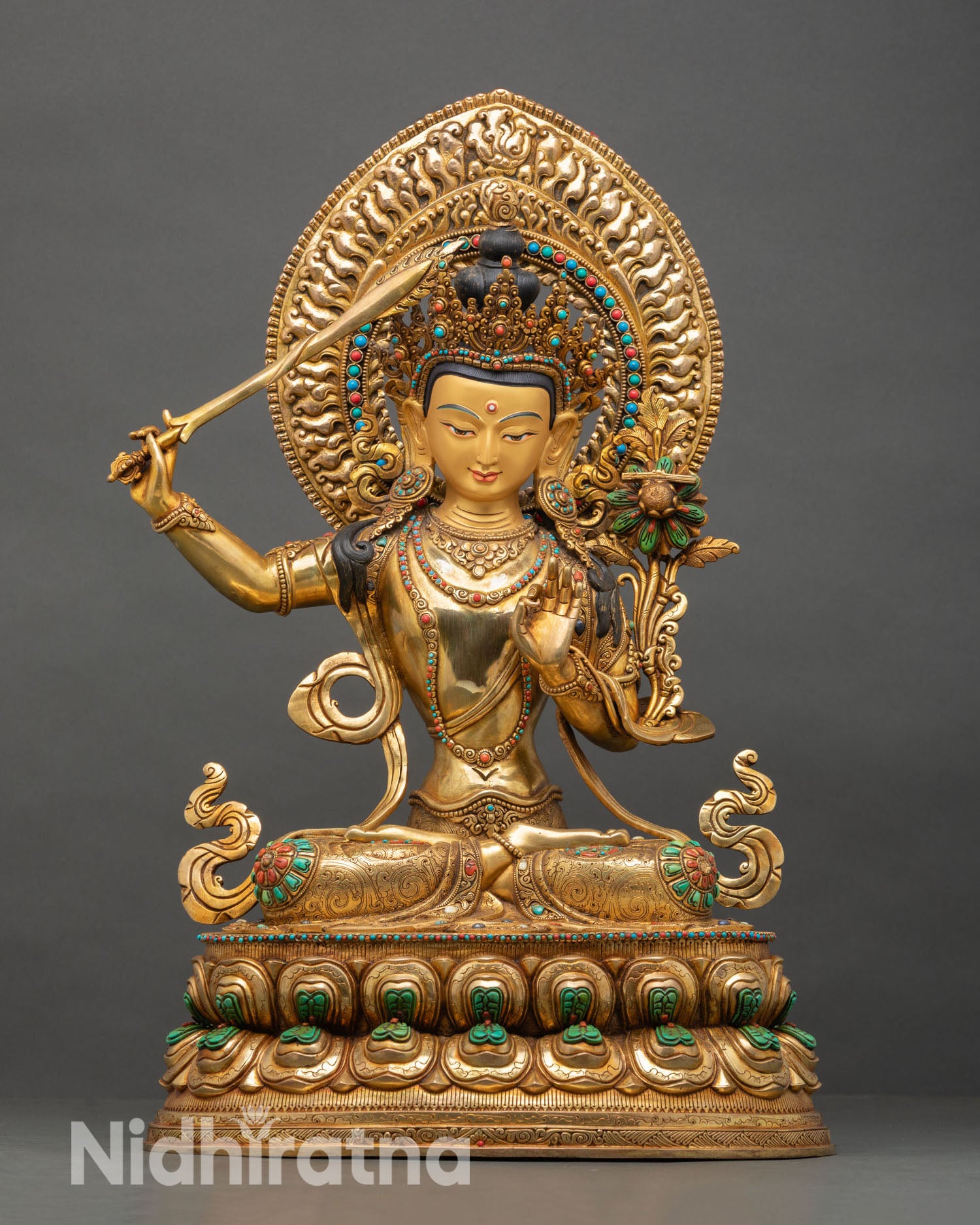 Front view of Manjushri statue, copper sculpture 24K gold fire gilding Kathmandu Valley handcrafted bodhisattva wisdom sword flaming Himalayan sacred art