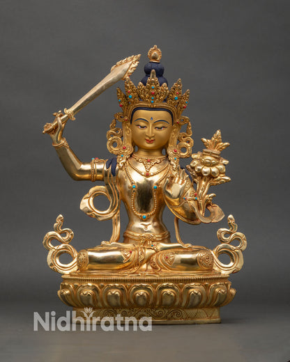Front view Manjushri statue radiating wisdom with gold gilding and lotus pedestal