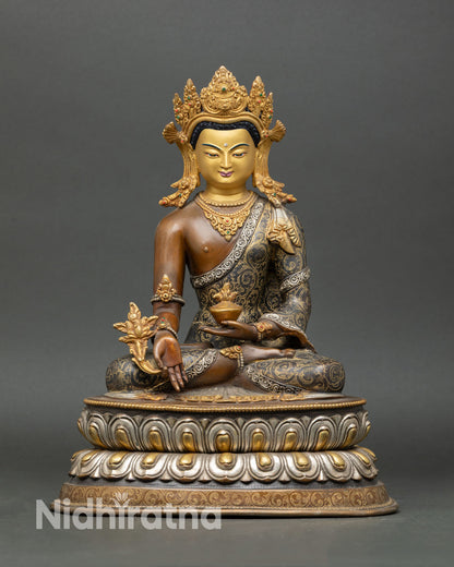 Front view of Medicine Buddha statue, copper oxidized finish, gold painted face, five jewel crown, semi precious stones, altar sculpture Nepal