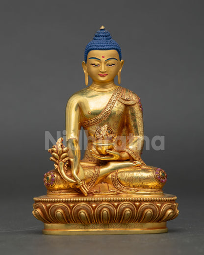 Front view of Medicine Buddha statue handcrafted in copper with 24k gold gilding semi precious stones and serene healing expression