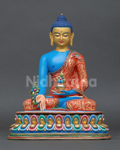 Front view of Medicine Buddha statue handmade in Nepal by skilled artisans lost wax copper sculpture with gold gilded face blue hued body for healing and meditation