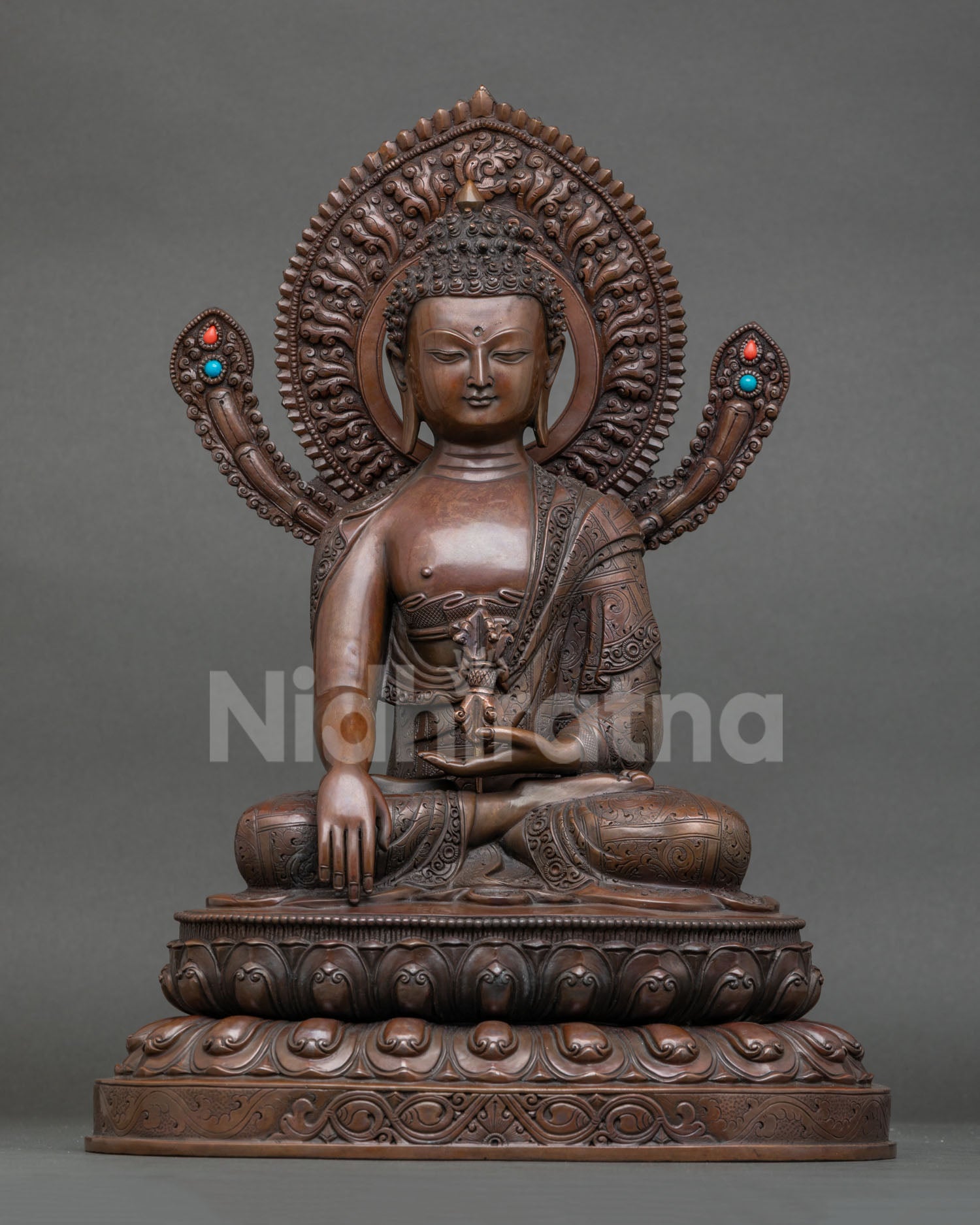 Front view of Mitrugpa Buddha statue in oxidized copper with lotus throne and vajra