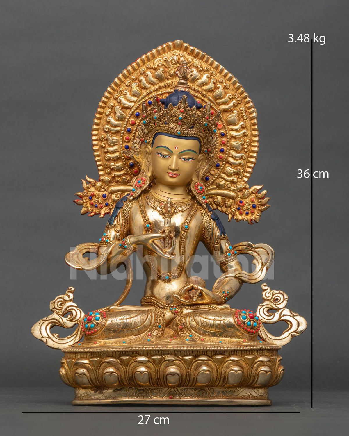 Front view of 24K gold fire-gilded Vajrasattva statue from Nepal with ornate flame halo