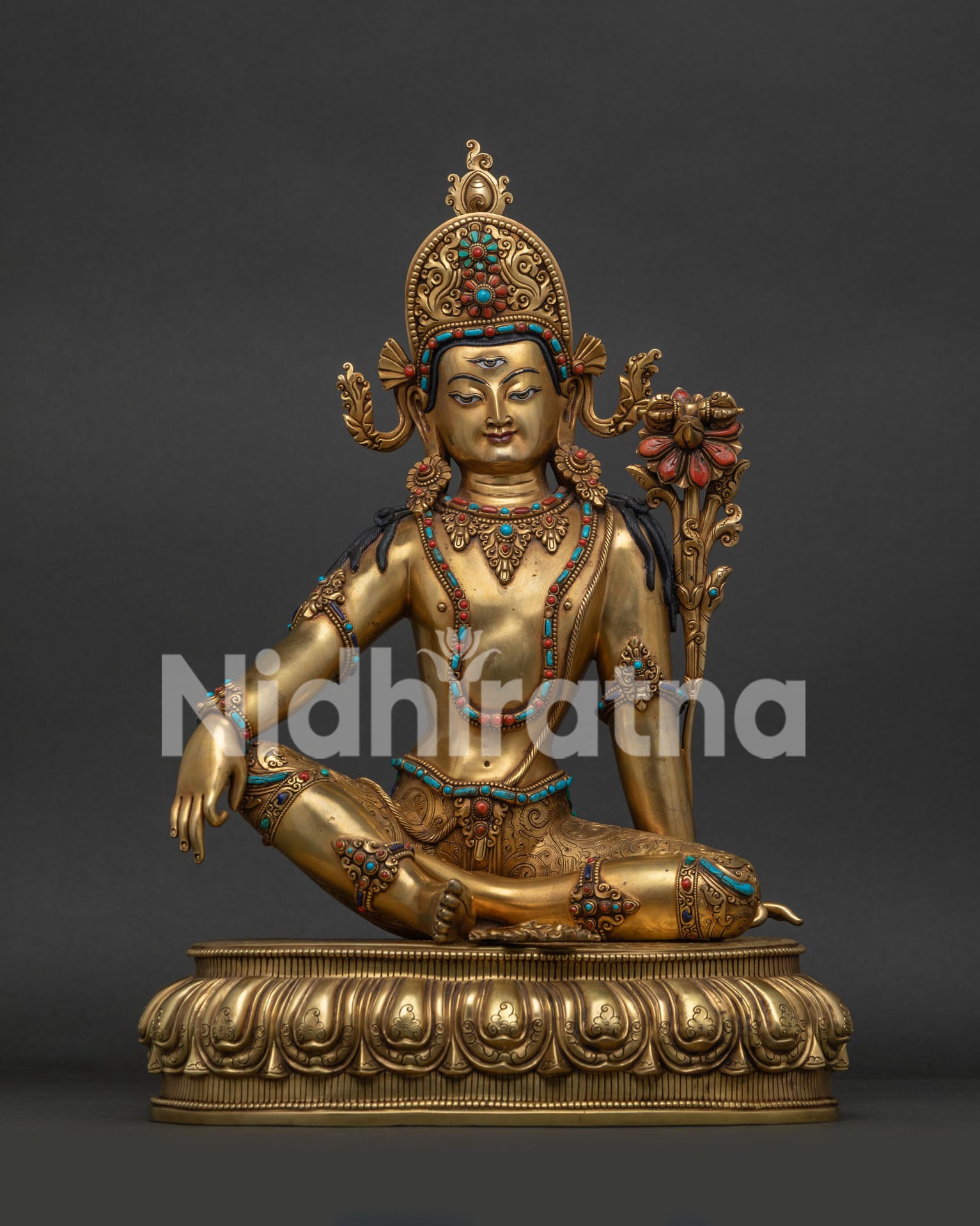 Front view of 24K gold-gilded Sakra Indra Buddhist statue seated on a lotus pedestal