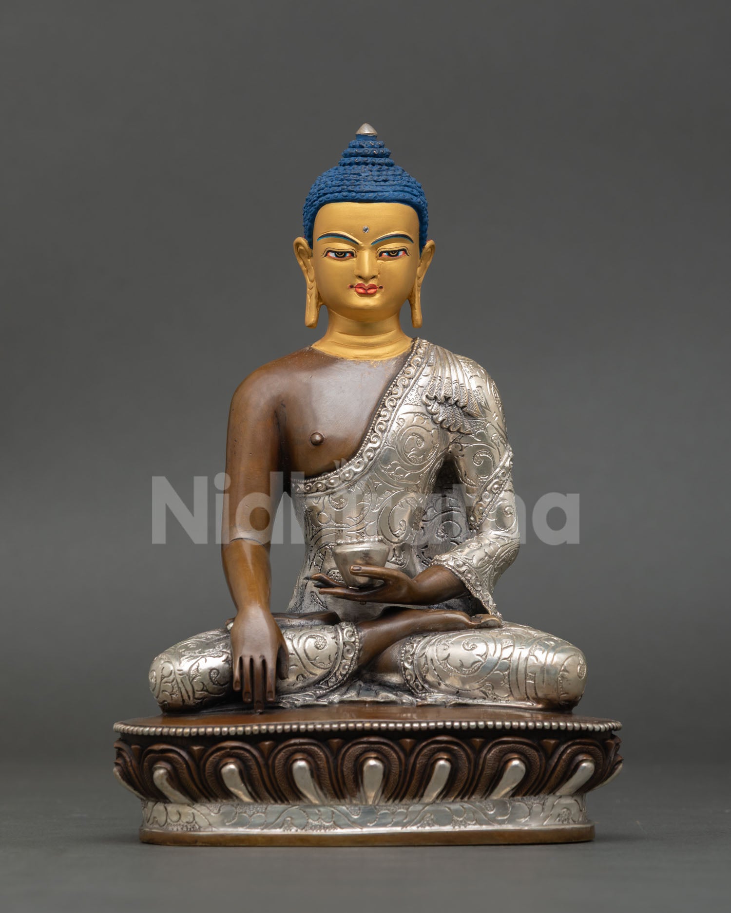 Front view of a handmade Shakyamuni Buddha statue with an oxidized silver-plated copper finish from Nepal