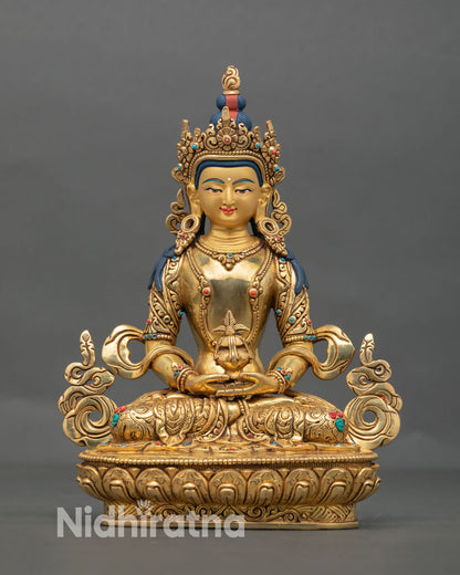 Front view of Amitayus statue handmade in Nepal with 24K gold fire gilded copper, five jeweled crown, and serene expression seated on lotus throne