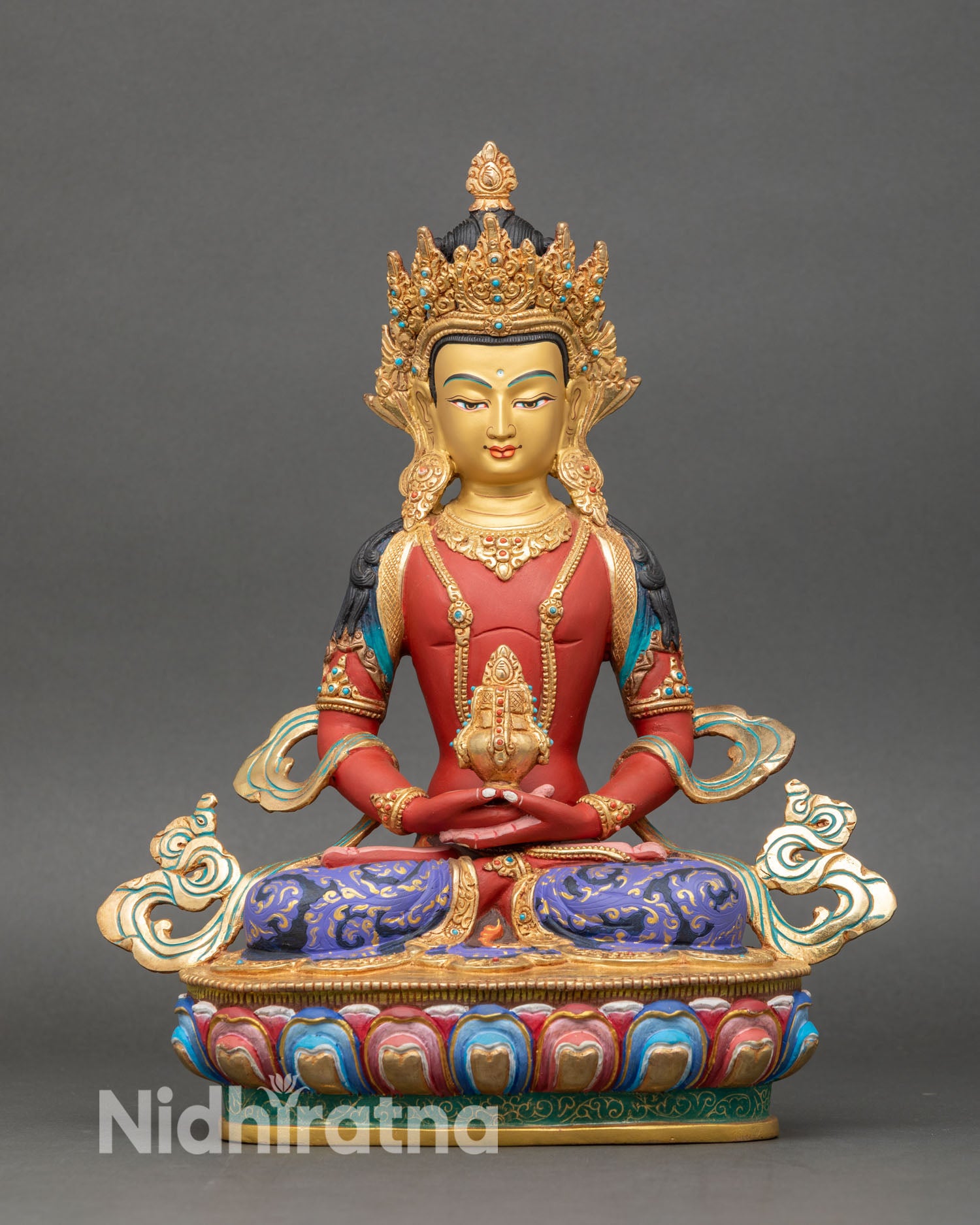 front view of amitayus statue holding kalasha vase with gold-painted face