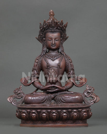 Front view of Amitayus statue in oxidized copper, seated on lotus throne with sacred vase