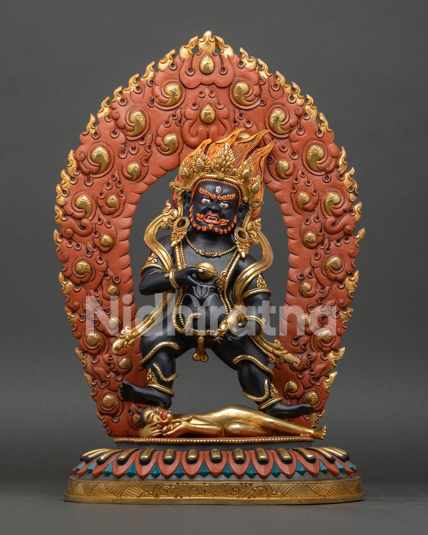Front view of Black Dzambhala statue, handmade in Nepal, cast in copper with gold gilded details
