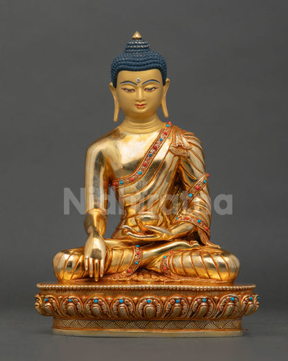 Front view of Buddha Shakyamuni statue, handmade in copper with gold gilding and semi-precious stones from Nepal