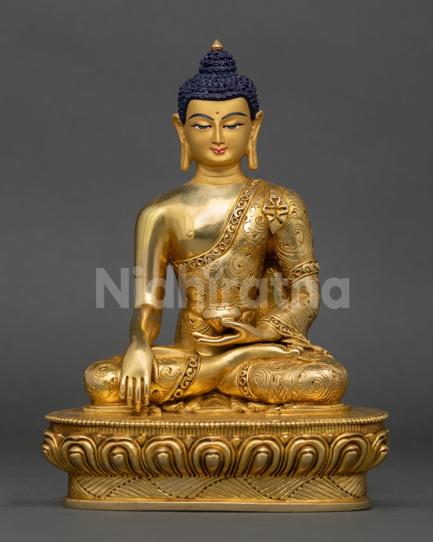 Front view of Buddha Shakyamuni statue seated in meditation posture on lotus base from Nepal