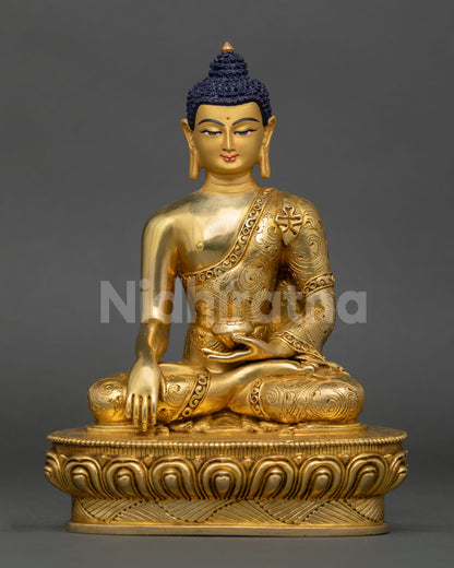 Front view of Buddha Shakyamuni statue seated in meditation posture on lotus base from Nepal