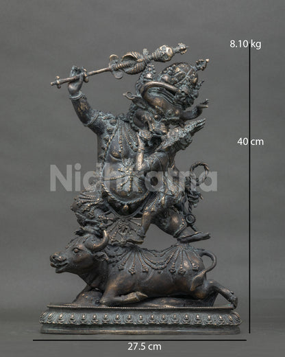 Front view of buffalo-headed Yamantaka Vajrabhairava bronze statue atop prostrate buffalo, Nepal