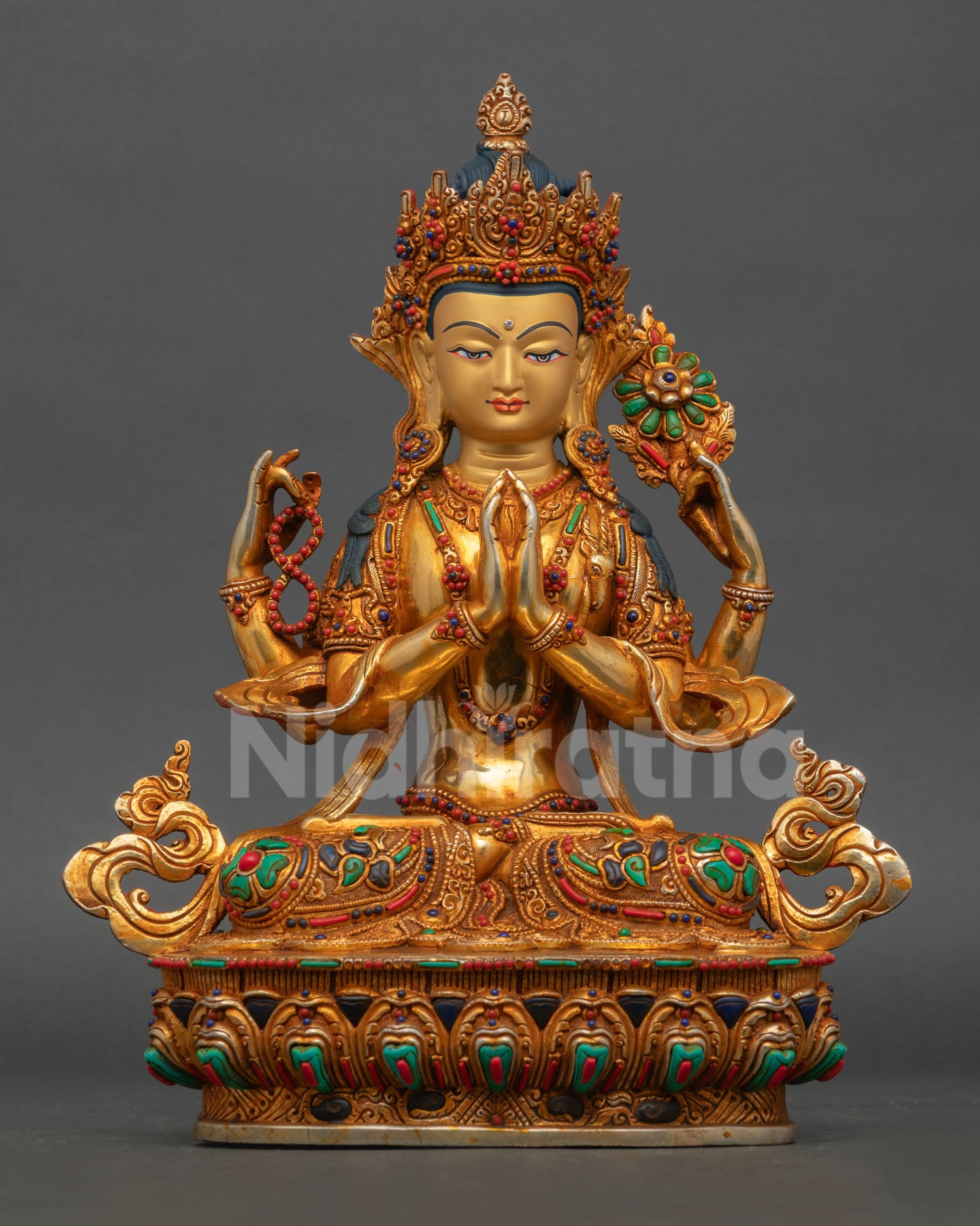 Front view of Chenrezig Avalokiteshvara statue, handmade in copper with gold accents, semi-precious stones, and a gold-painted face from Nepal