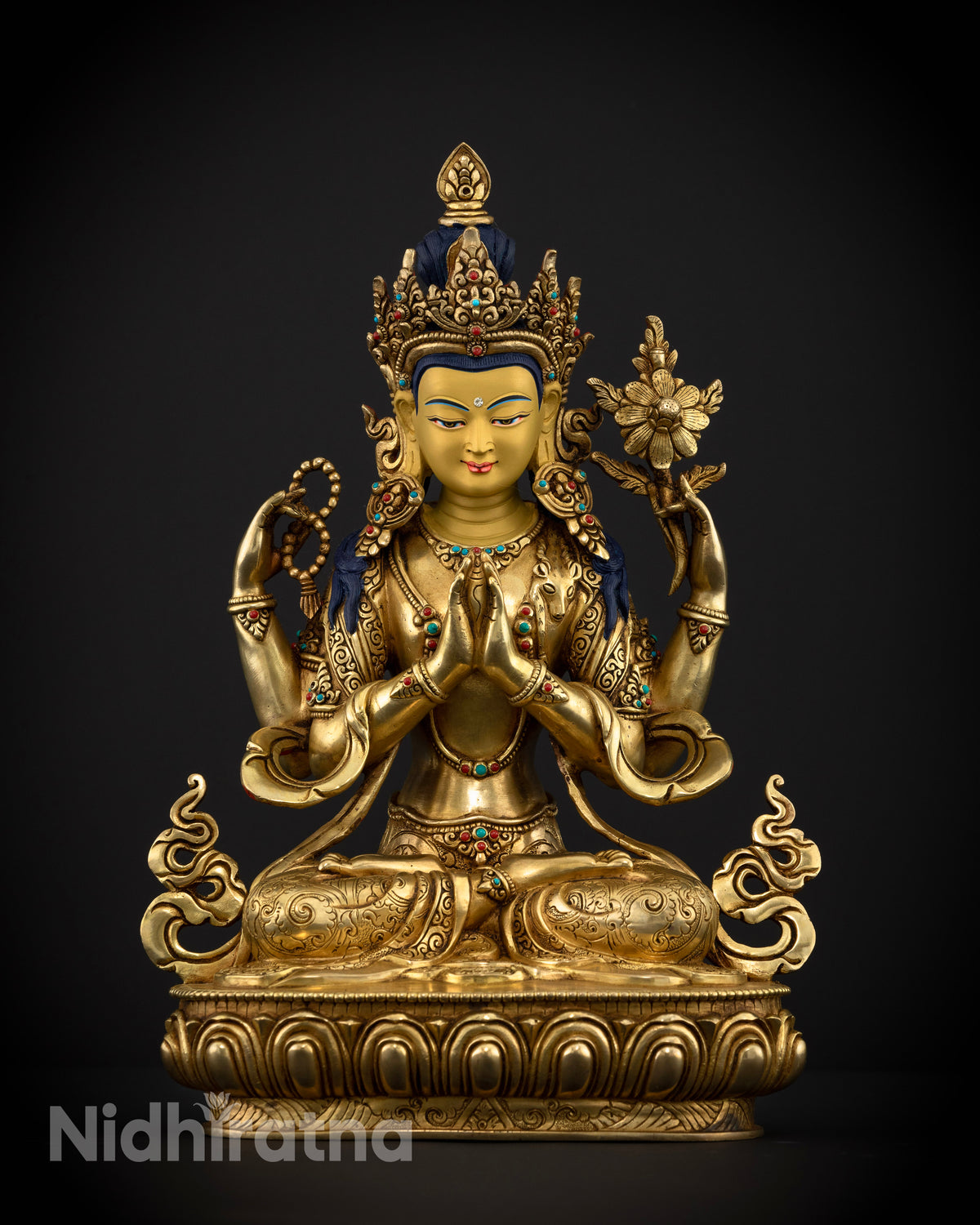 Front view of Chenrezig Statue handcrafted in Nepal with gold fire-gilding, semi-precious stones, and an intricately carved lotus pedestal.