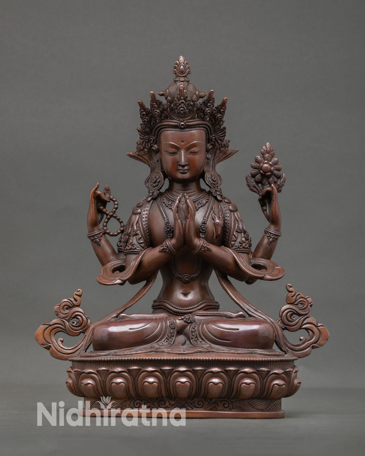 Front view of Chenrezig statue with oxidized copper finish, calm compassionate expression representing Bodhisattva of compassion