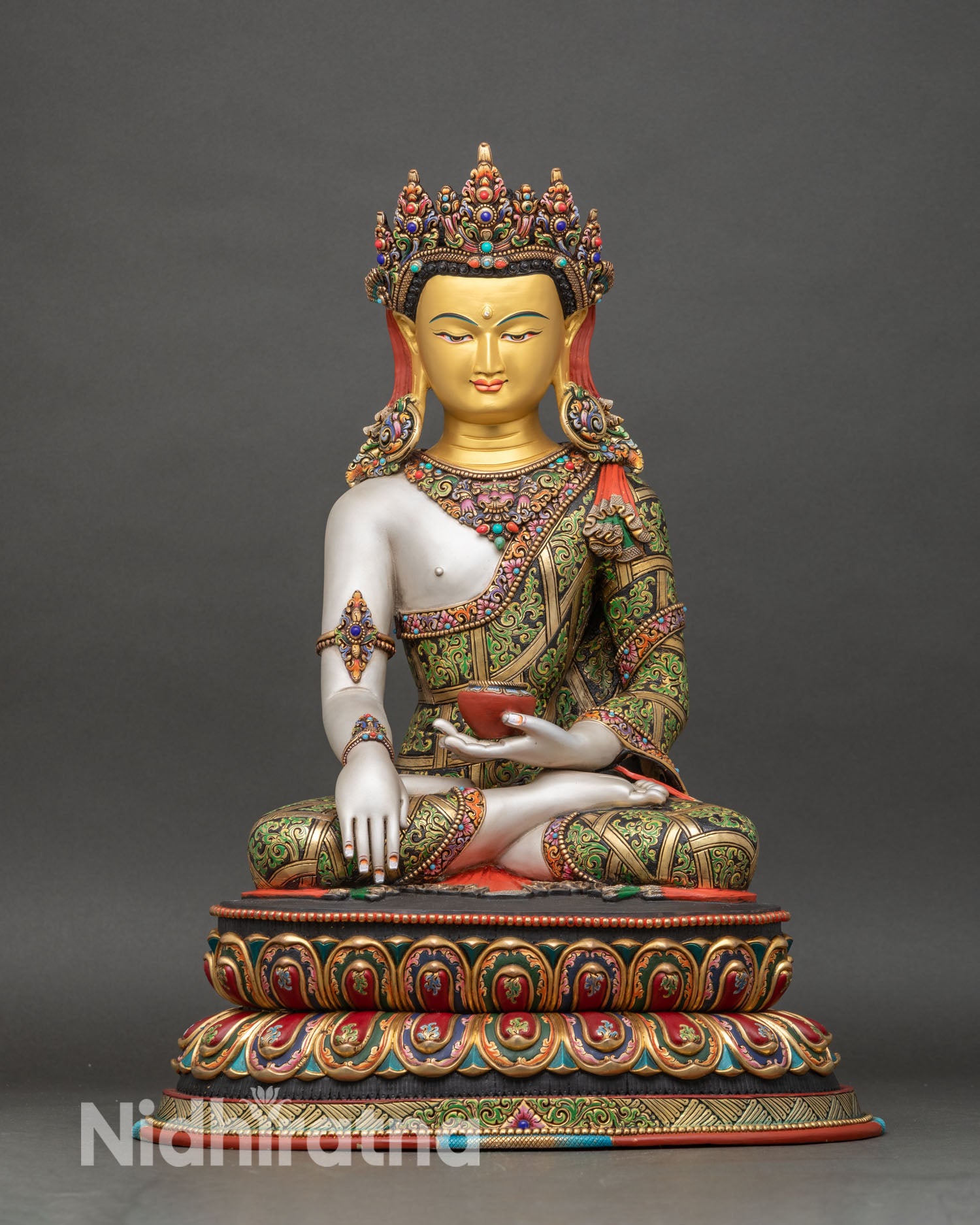 front view of crown shakyamuni buddha statue gold-painted with green robes on double-lotus pedestal