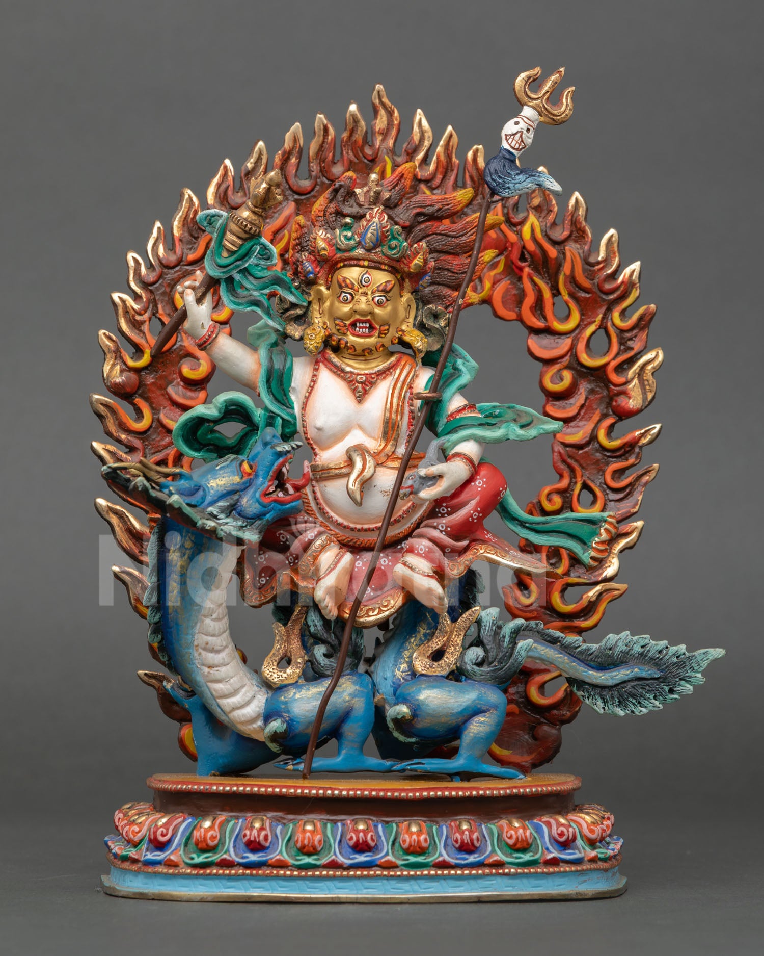 Front view of Dragon-riding White Dzambhala statue handcrafted in Nepal using lost-wax casting with 24K gold-painted face and copper body