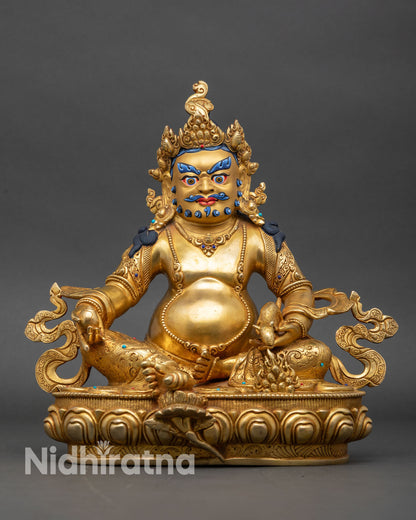 Front view of Dzambhala statue gold fire-gilded copper lotus pedestal Nepal