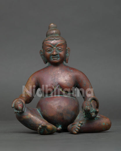 front view of dzambhala statue holding mongoose symbol of prosperity and abundance