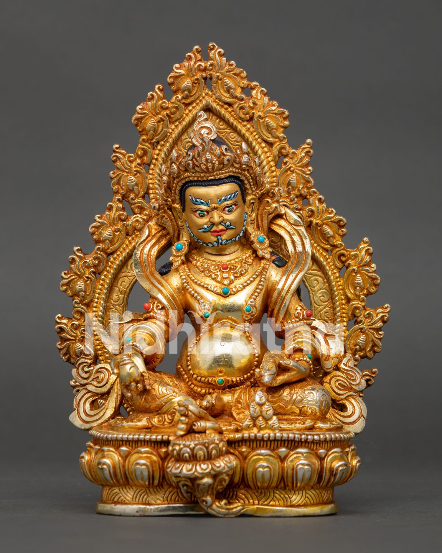 Front view of Dzambhala statue seated on lotus throne with sacred Buddhist symbolism