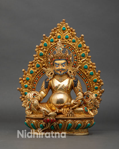 Front view of Dzambhala wealth deity statue, gold-gilded Buddhist sculpture from Nepal