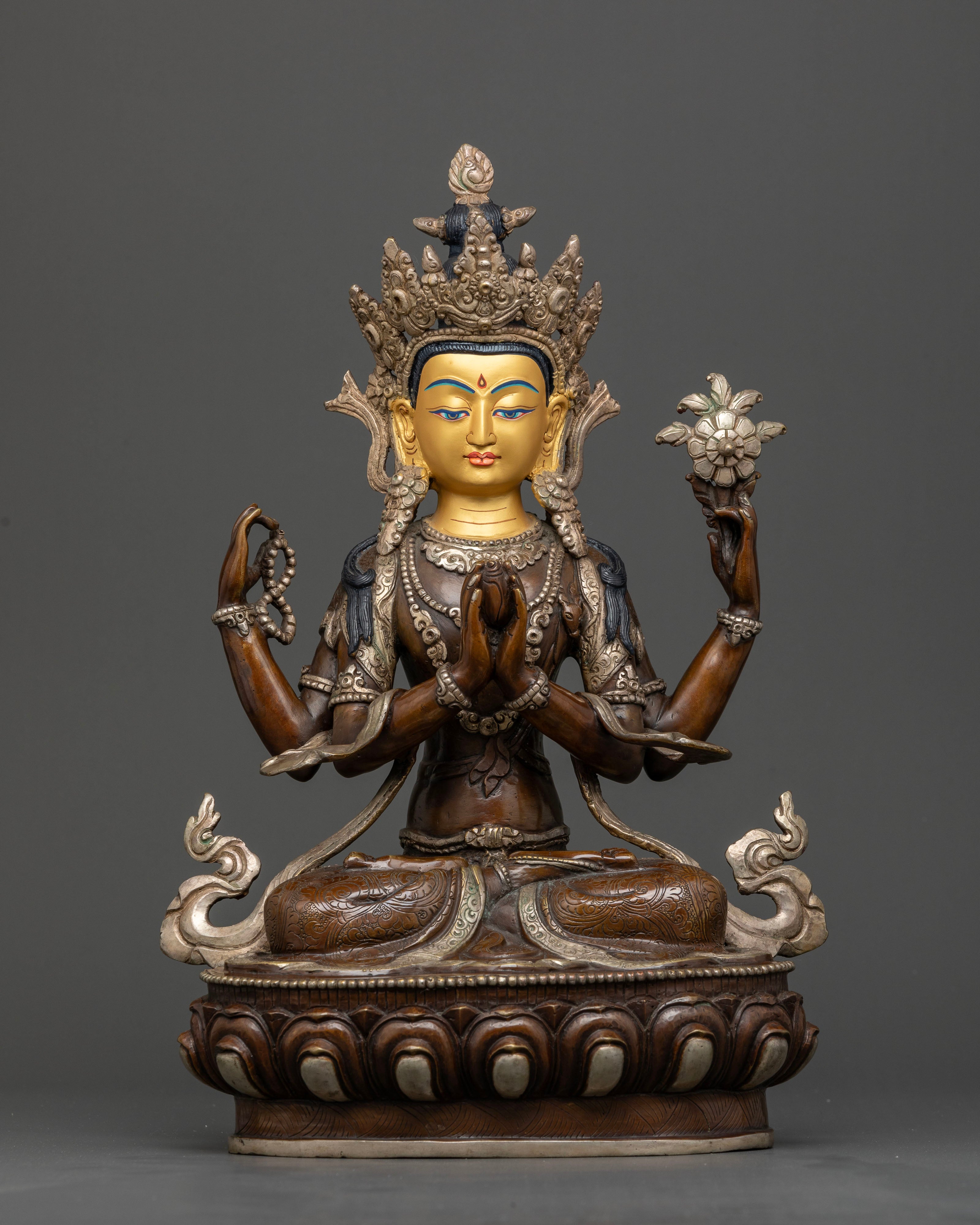 Front view of Four Armed Chenrezig statue with gold painted face from Nepal