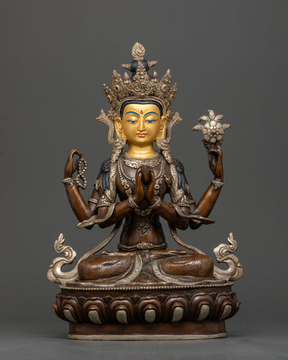 Front view of Four Armed Chenrezig statue with gold painted face from Nepal