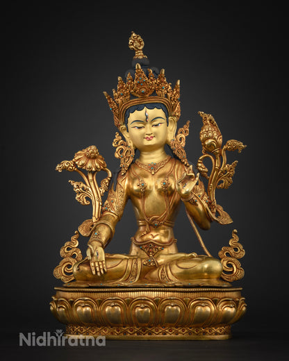 Front view of gold fire-gilded White Tara Buddhist statue seated on lotus pedestal, Nepal