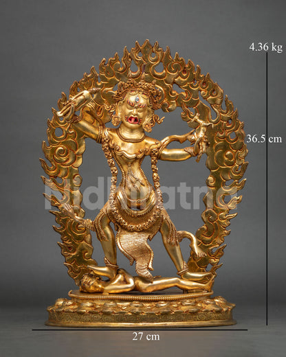 Front view of gold gilded copper Ekajati statue with curved knife and skull cup in flame halo