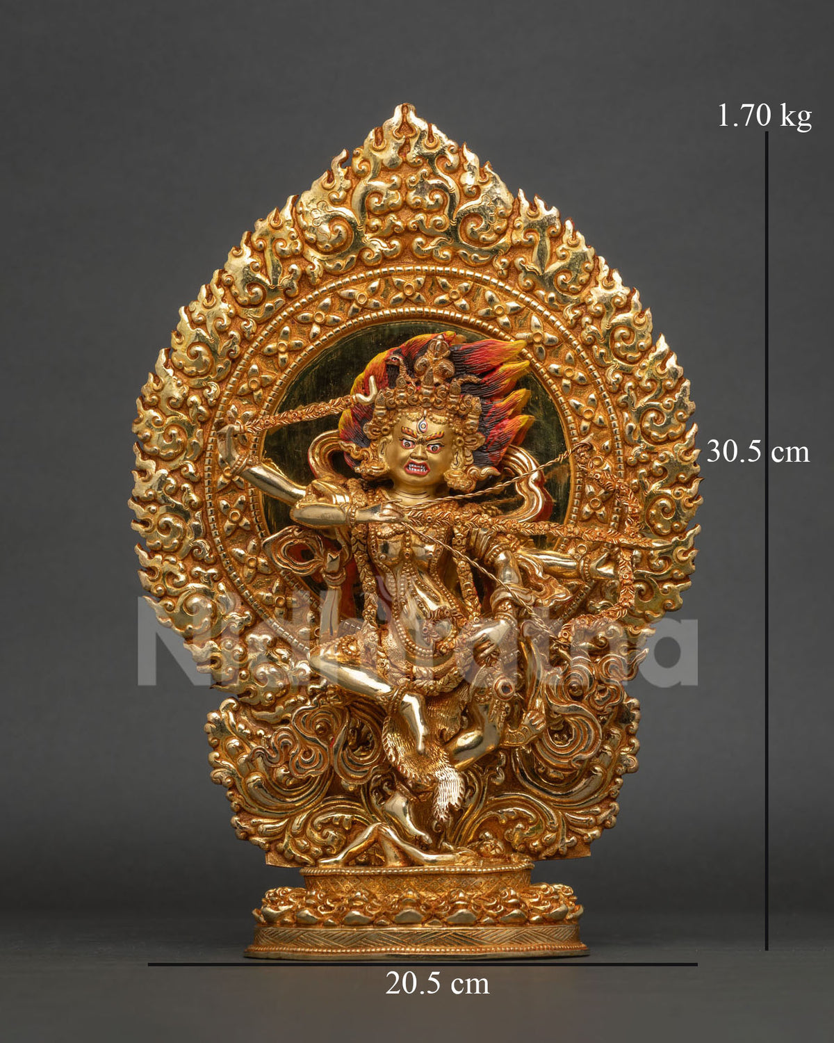 Front view of gold gilded kurukulla statue with red form flaming hair and skull halo.