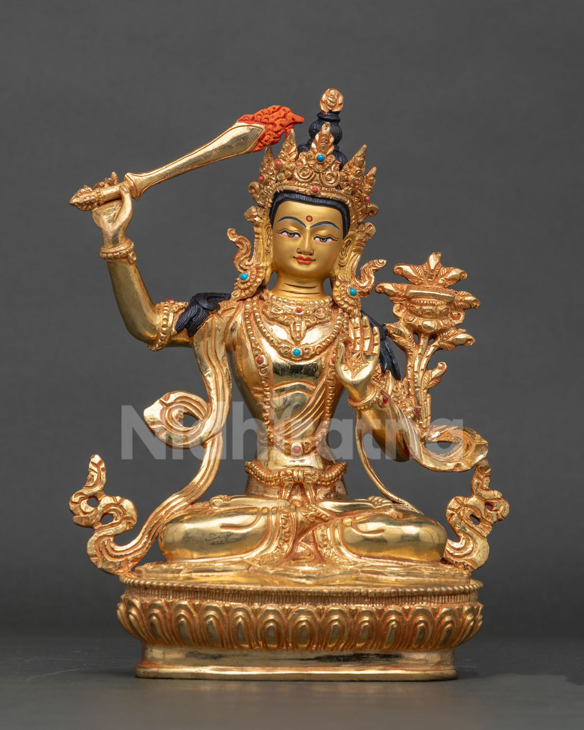 Front view of gold Manjushri statue with raised flaming sword and lotus base, Nepal Buddhist art