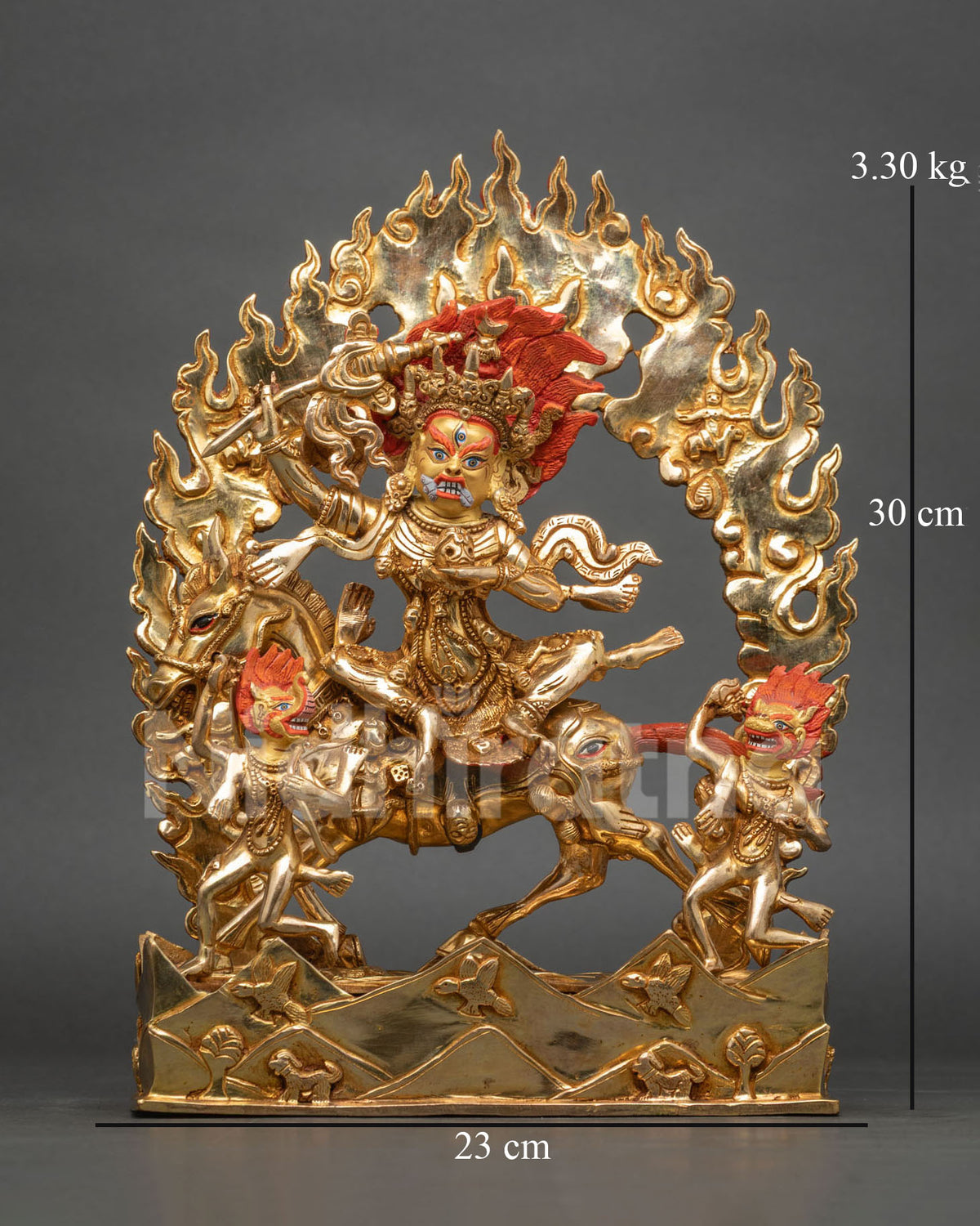 Front view of gold Palden Lhamo statue on mule within flaming halo and mountain base