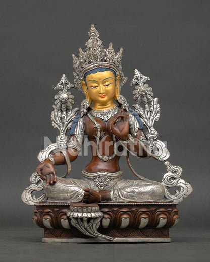 Front view of Green Tara statue handcrafted in Nepal with oxidized silver finish gold painted face and lotus throne