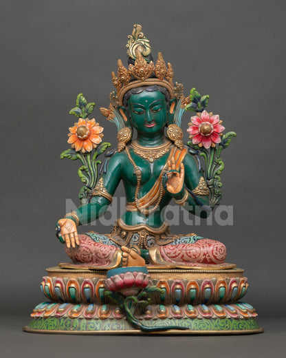 Front view of Green Tara statue in copper with gold gilding seated on lotus throne