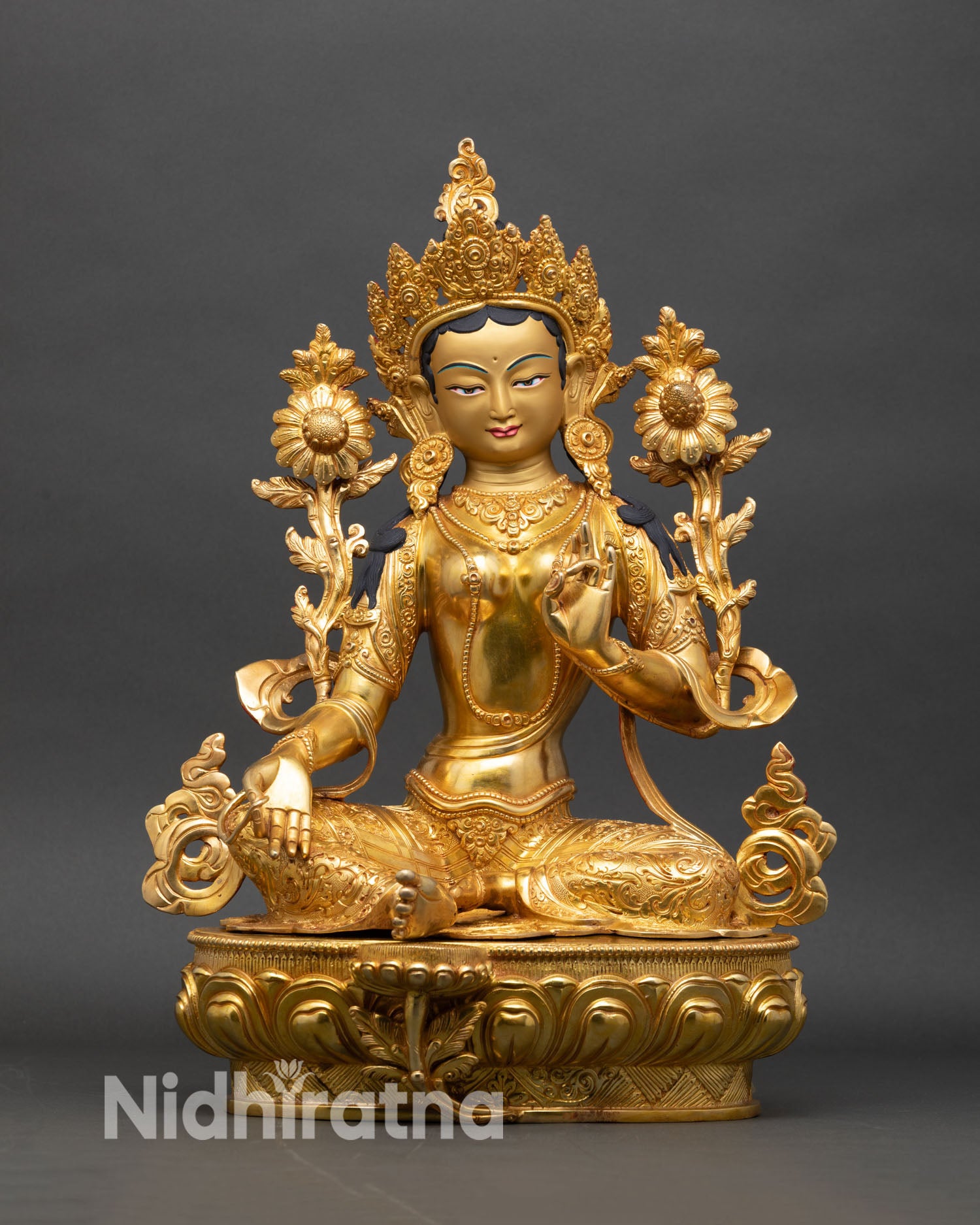 Front view of Green Tara statue seated on lotus pedestal with gold detailing