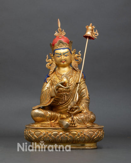 front view of guru norlha statue seated on lotus with jewel mongoose and khatvanga staff