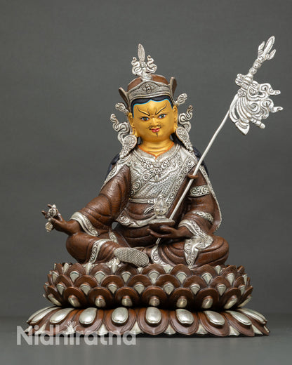 Front view of Guru Rinpoche statue handcrafted Nepalese lost wax copper sculpture with oxidized silver plated finish gold painted face and lotus seat for shrine decor