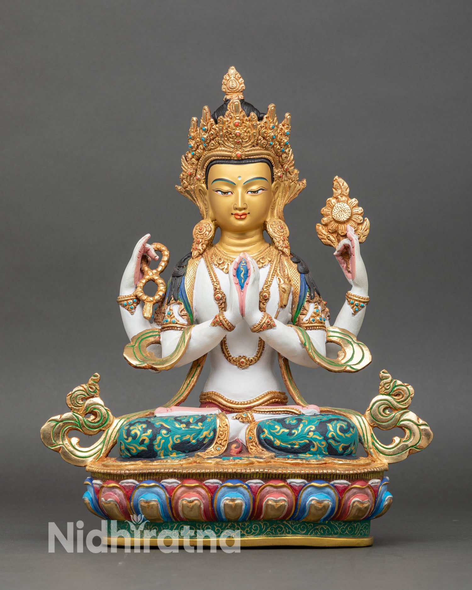 front view of hand-painted chenrezig statue with gold-gilded jewelry and copper base