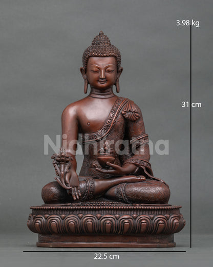 Front view of handcrafted copper Bhaisajyaguru Medicine Buddha statue with brown patina