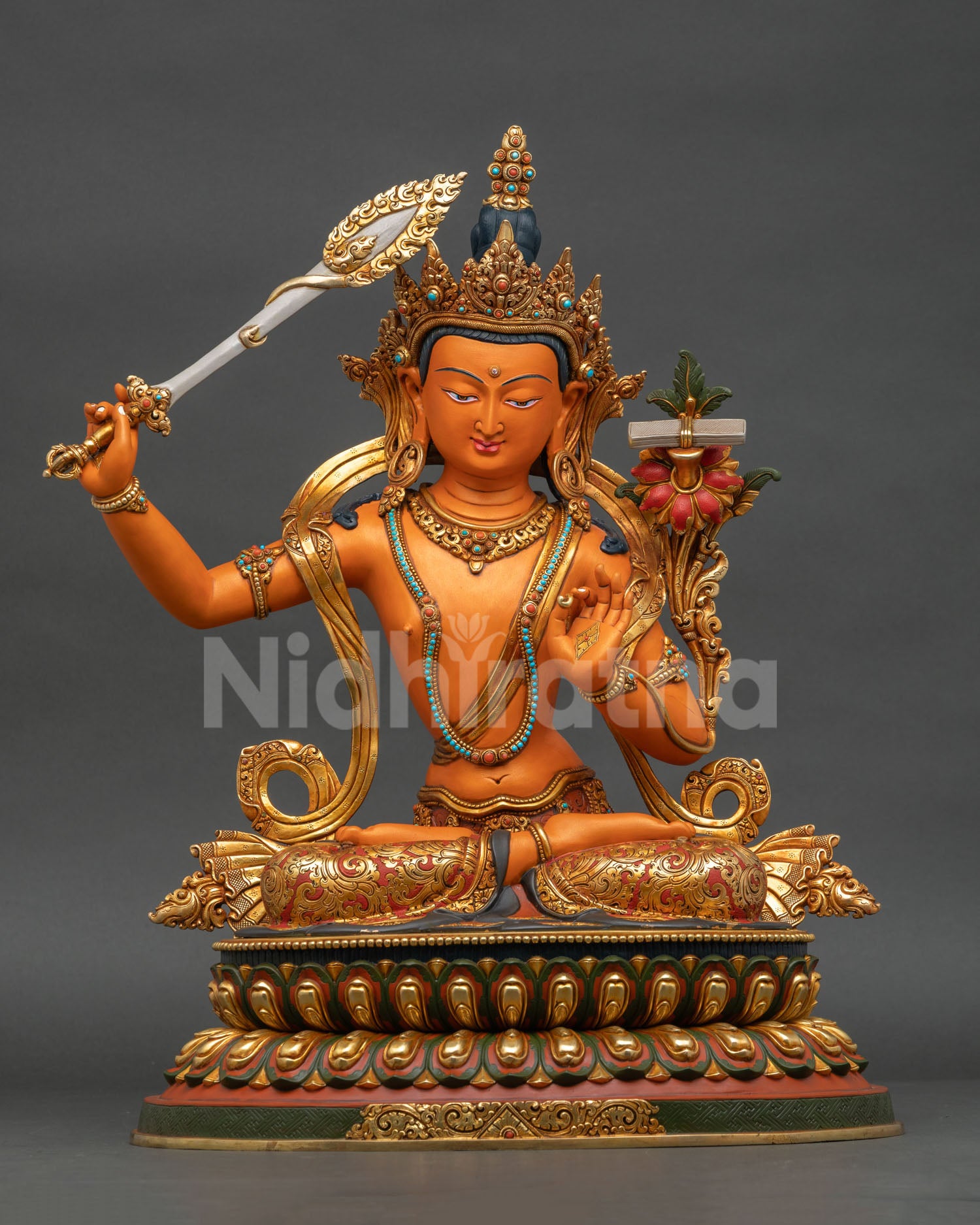 Front view of handcrafted copper Manjushri Statue with gold gilding and acrylic-painted details.