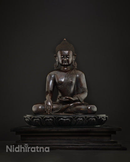 Front view of handcrafted copper Shakyamuni Buddha statue with brownish patina and serene expression