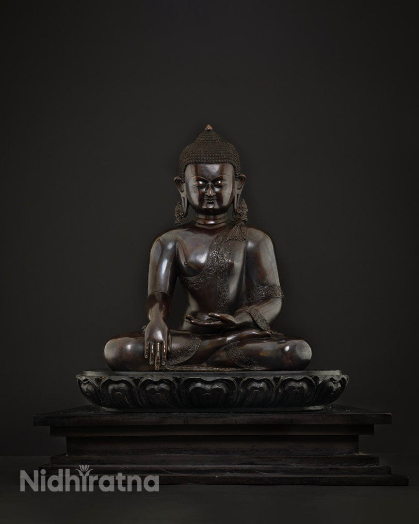 Front view of handcrafted copper Shakyamuni Buddha statue with brownish patina and serene expression