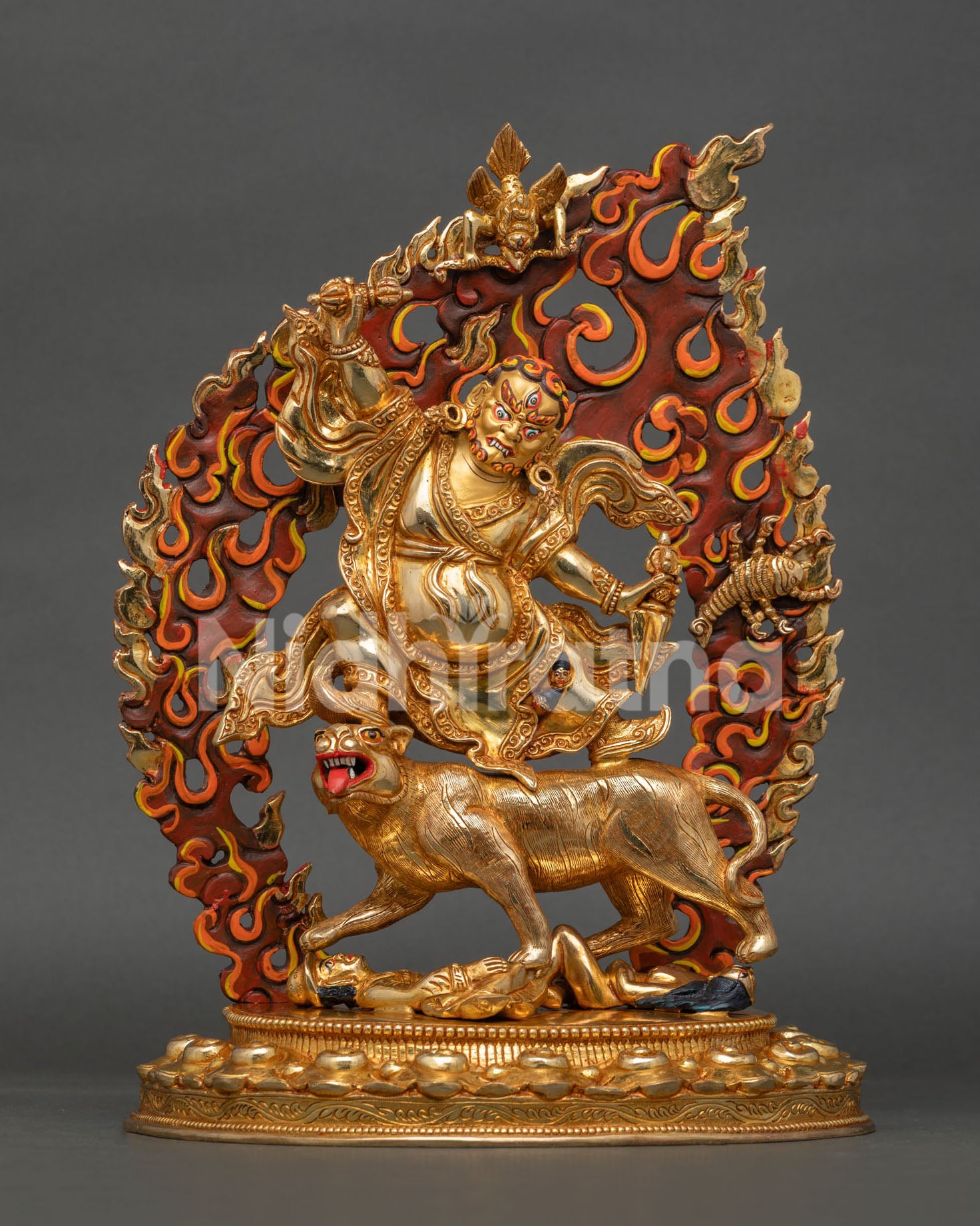 Front view of handcrafted Dorje Drolo Statue from Nepal featuring 24K gold gilding, blazing flames, Vajra, Phurba, and white tigress imagery.