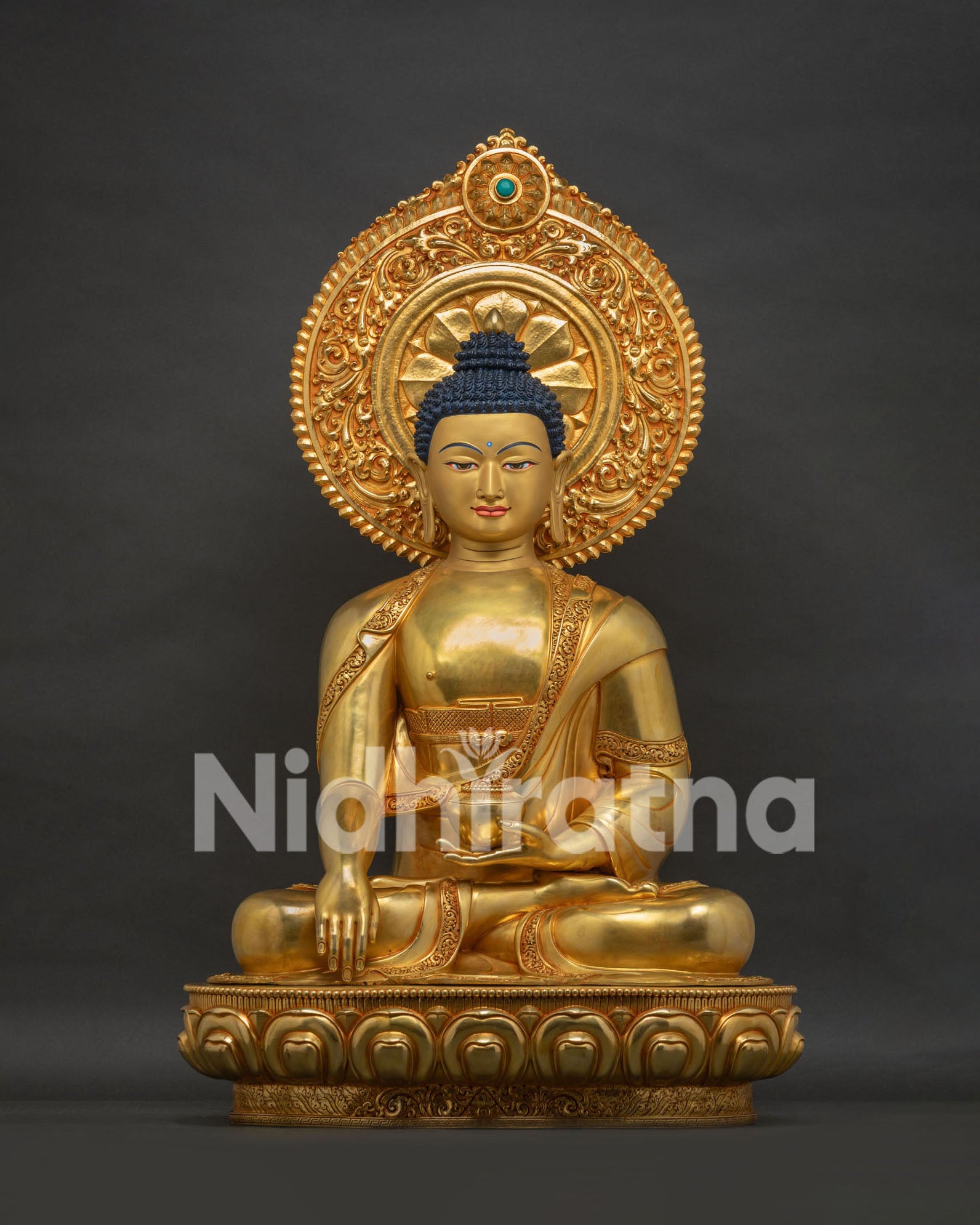 Front view of handcrafted gold gilded Shakyamuni Buddha statue seated in meditation