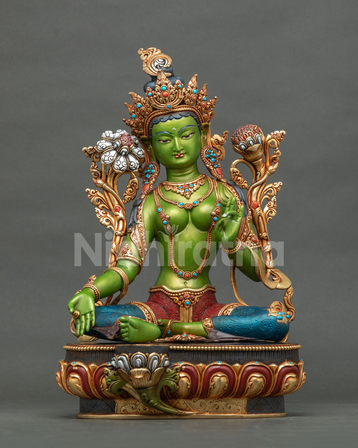 Front view of handcrafted Green Tara statue on lotus pedestal with gold crown and jewelry